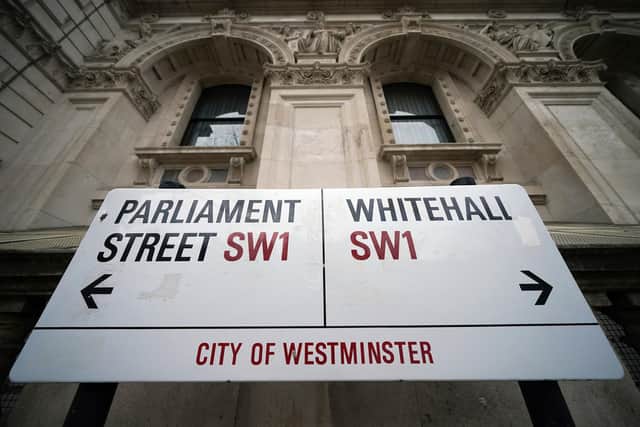 Photo of a street sign giving directions to Parliament Street and Whitehall in London.