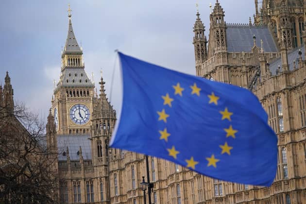 A European Union flag flies in front of the Houses of Parliament in Westminster, London. PIC: PA