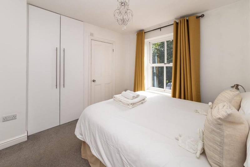 The house has three bedrooms including this double one with a built-in wardrobe