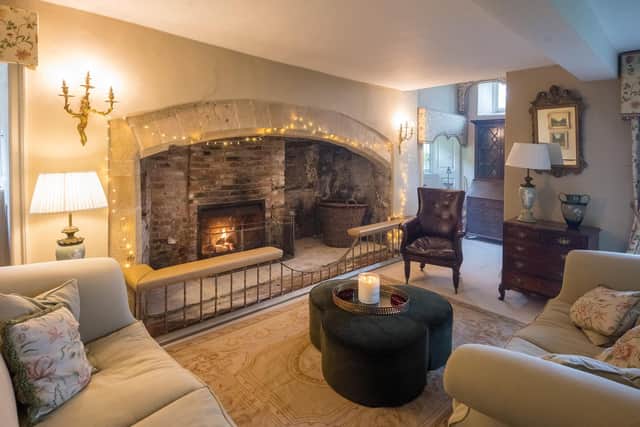 A cosy sitting room with an inglenook fireplace