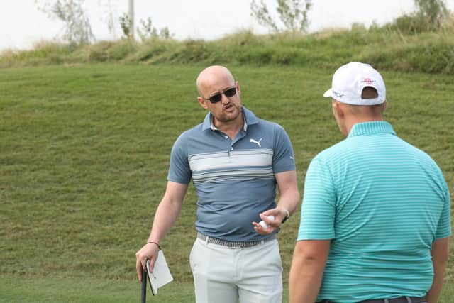 Guidance: Duncan McCarthy, left, chats with his client Marcus Armitage at the recent Abu Dhabi Golf Championship on the DP World Tour. (Picture: Kevin Murray)