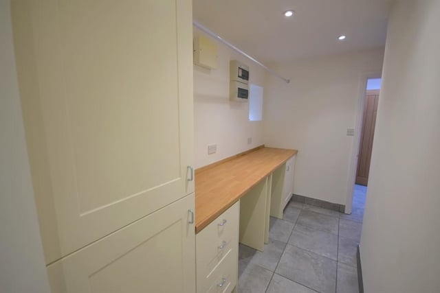 A spacious utility room with a range of matching cream units and contrasting work surfaces. The combination boiler is concealed within one of the cupboards. There is plumbing for a washing machine and space for a dryer. A small feature window allows natural light, access into a versatile area approximately 7x 8"3 having radiator, socket point and downlights.