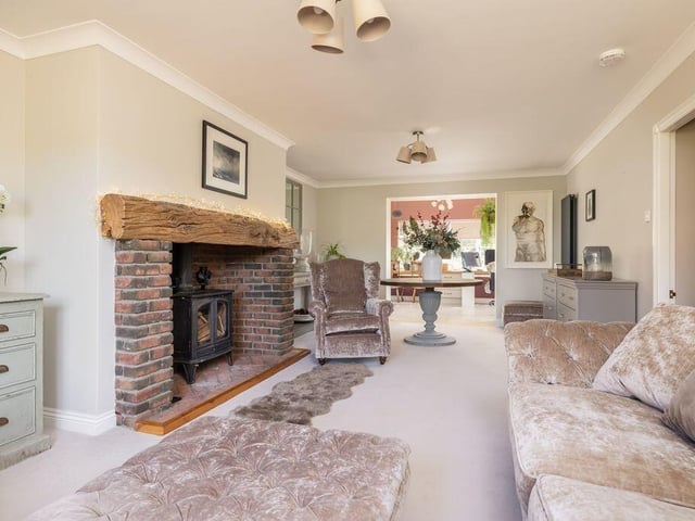 The generous sitting room flows directly into the garden room, extending the living space towards the outdoors.