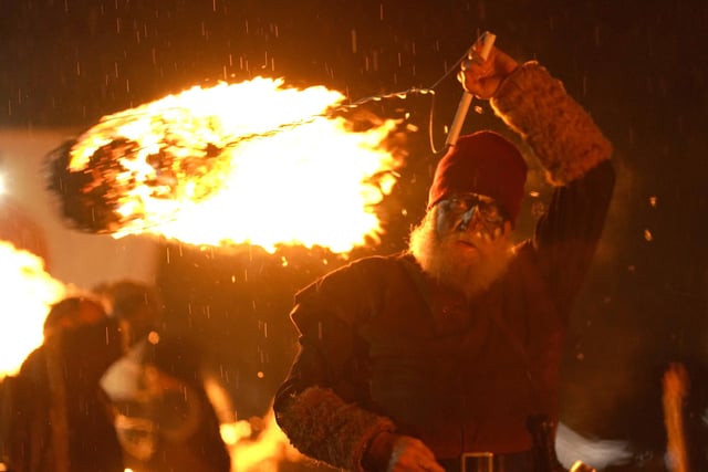 Viking reenactors use flaming torches during the Flamborough Fire Festival, a Viking themed parade in aid of charities and local community groups, held on New Year's Eve in Flamborough near Bridlington, Yorkshire. Picture date: Saturday December 31, 2022.