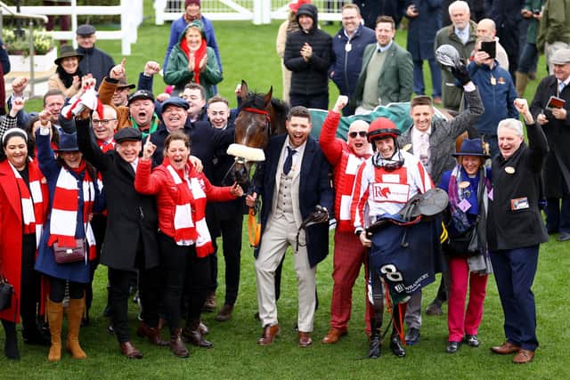 Cheltenham roar: Jockey Sam Twiston-Davies celebrates with team after riding The Real Whacker to win the Brown Advisory Novices' Chase.
(Photo by Michael Steele/Getty Images)