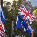 AUnion flag and EU flag outside the Houses of Parliament, London. PIC: Steve Parsons/PA Wire