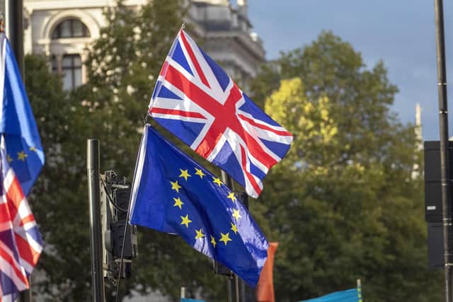 AUnion flag and EU flag outside the Houses of Parliament, London. PIC: Steve Parsons/PA Wire