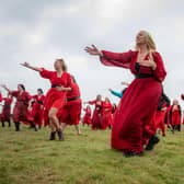 Participants gather at Penistone Country Park in Haworth for Actually the Most Wuthering Heights Day Ever - a celebration of all things Wuthering Heights, Kate Bush and Emily Brontë in the stunning setting of the Haworth moors.  500 people took part in the mass 'Wuther' in a joyful, windswept, red-dress sea of Cathys dancing for charity, supporting  Women’s Aid Picture by Tony Johnson.  24th July 2026