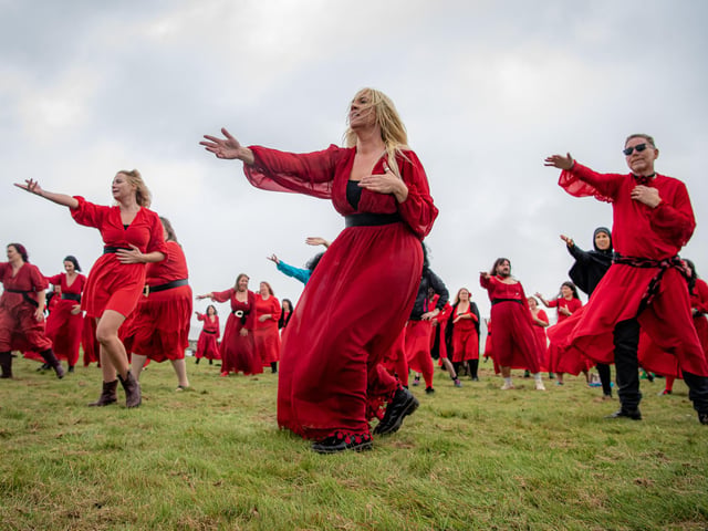 Participants gather at Penistone Country Park in Haworth for Actually the Most Wuthering Heights Day Ever - a celebration of all things Wuthering Heights, Kate Bush and Emily Brontë in the stunning setting of the Haworth moors.  500 people took part in the mass 'Wuther' in a joyful, windswept, red-dress sea of Cathys dancing for charity, supporting  Women’s Aid Picture by Tony Johnson.  24th July 2026