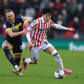 STOKE ON TRENT, ENGLAND - MARCH 02:  Bae Jun-Ho of Stoke City runs past Luke Ayling of Middlesbrough during the Sky Bet Championship match between Stoke City and Middlesbrough at Bet365 Stadium on March 02, 2024 in Stoke on Trent, England. (Photo by Nathan Stirk/Getty Images)