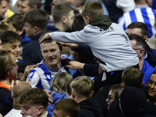 UNIQUE: Sheffield Wednesday striker Michael Smith leaves the pitch surrounded by fans after his side's incredible play-off comeback