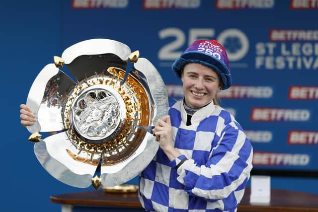 Saffie Osborne lifts the trophy after winning the Betfred St Leger Stakes on day three of the Betfred St Leger Festival at Doncaster Racecourse. (Picture: Richard Sellers/PA Wire)