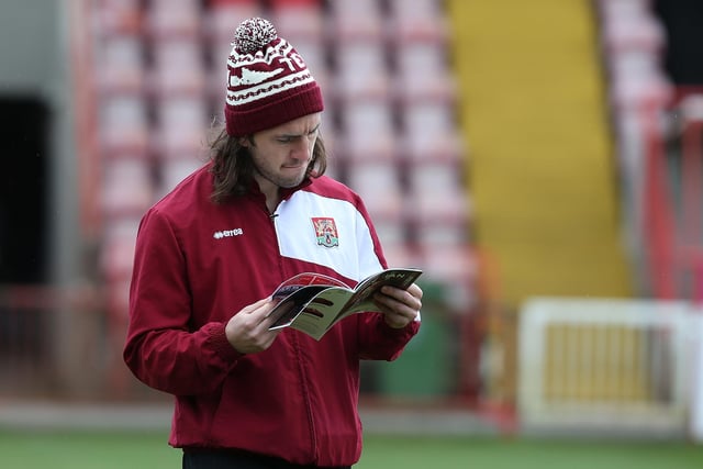 John-Joe O'Toole reads the matchday programme prior to the Sky Bet League Two match between Exeter City and Northampton Town at St James Park on April 16, 2016.