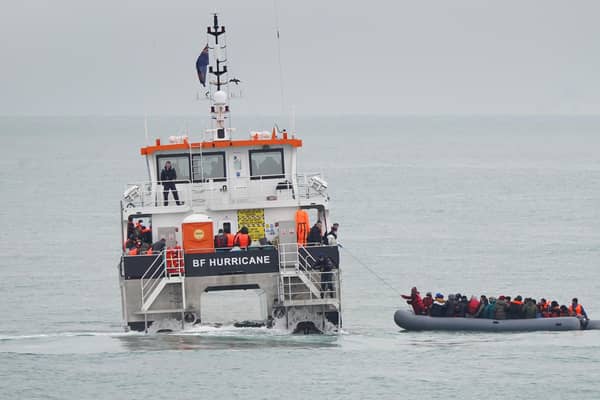 A group of people, believed to be refugees, are rescued off the coast of Folkestone by a Border Force vessel