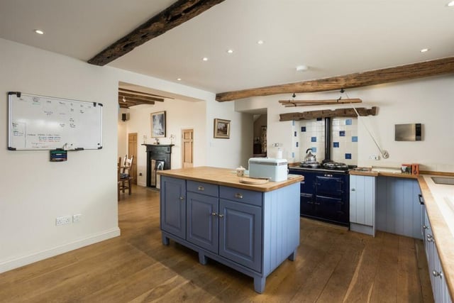 At the heart of the house is the inter-connecting kitchen and dining room which extends some 25 ft and has a north/south aspect. The kitchen has a wooden floor, free-standing island, fitted units, integrated appliances, an oil-fired Aga in a recessed hearth.