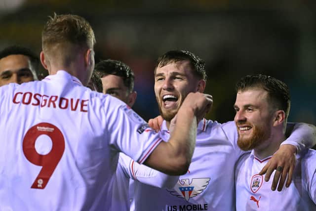 ON THE MARK: Barnsley's John McAtee (second right) celebrates the team's second goal against Carlisle United at Brunton Park on Tuesday night. Picture: Stu Forster/Getty Images