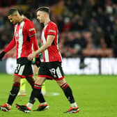 DEJECTED: Vinicius Souza (left) and Jack Robinson trudge back after another Arsenal goal