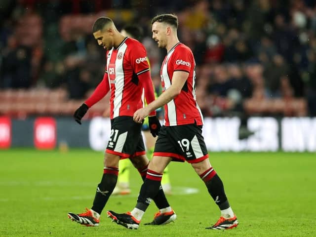 DEJECTED: Vinicius Souza (left) and Jack Robinson trudge back after another Arsenal goal