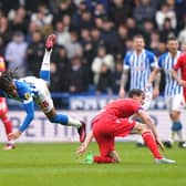 FLYING IN: Huddersfield Town's David Kasumu (left) takes a tumble after Tyler Morton's tackle
