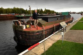 Andy Spicer is pictured on a 1939 Liveaboard Barge which is also in the auction. Picture by Simon Hulme