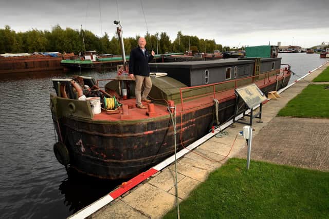 Andy Spicer is pictured on a 1939 Liveaboard Barge which is also in the auction. Picture by Simon Hulme