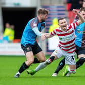 Doncaster Rovers' striker Caolan Lavery falls under pressure from Northampton's Jack Sowerby. Picture: Bruce Rollinson