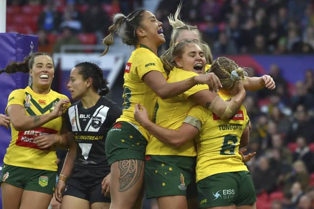 Australia's Emma Tonegato, right, celebrates after scoring a try. (AP Photo/Rui Vieira)