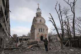 A Ukrainian serviceman takes a photograph of a damaged church after shelling in a residential district in Mariupol, Ukraine, March 10, 2022. (AP Photo/Evgeniy Maloletka, File)
