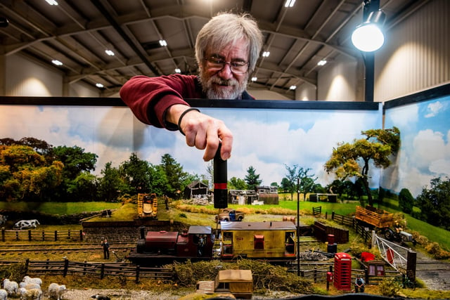 Colin Brown, carefully trying to link a locomotive onto a wagon of the 'Woodhill Goods' Thirsk - 0 Gauge Layout based on The Thirsk and Sowerby Light Railway which is a complete figment of the maker's imagination. However between 1898 and 1906 there was a link between Thirsk Station on the York and Newcastle Railway and the centre of Thirsk and its immediate surroundings including the village of Sowerby where the company built an engine shed to maintain its fleet of locomotives. The final goods-only section to Avenue Sidings, that opened in 1906, was severed by a landslip in 1948 and the line was cut back to Woodhill Goods.