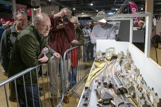 Visitors eagerly view the layouts at the event.
