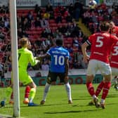 Glancing ahead: Jack Taylor, far right, heads the ball goalwards to beat Harry Isted, left, as Peterborough gatecrashed the top six with victory that leaves Barnsley with a few questions about momentum (Picture: Ian Hodgson/PA)