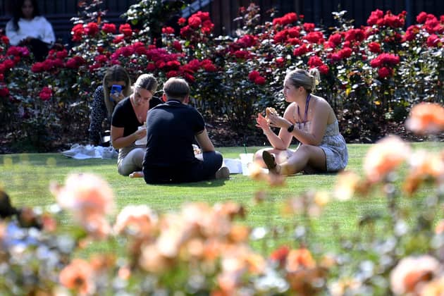 People sit out and enjoy the sunshine at Park Square, Leeds. Picture taken by Yorkshire Post Photographer Simon Hulme 4th September 2023