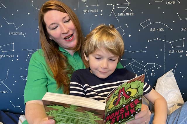 Anna Brooke reading her book Monster Stink to her son.
