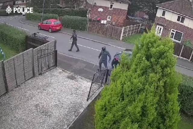 This is the shocking moment a pair of balaclava-clad thugs are caught on camera smashing up a car and a house in a 'violent attack'.