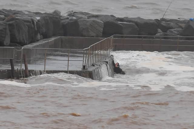 A couple had a lucky escape after being washed into the sea at Staithes - they are pictured climbing to safety.
Picture: Gerard Binks.