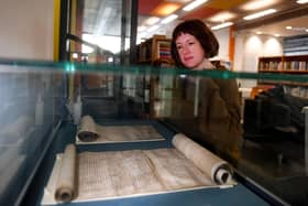 To mark the 725th anniversary, the exhibition '˜Hull/Ravenser Odd: twin cities, sunken pasts' will display the original Hull and Ravenser Odd charters, on loan from The National Archives. The exhibition will also highlight existing items in Hull History Centre's collection (Hull's 1299 charter, maps of medieval Hull), and bring the little-known story about the sinking of Ravenser Odd and the ascendancy of Hull to life. Dr Emily Robinson is pictured with the  charter roll from Edward I April 1st 1299..Picture taken by Yorkshire Post Photographer Simon Hulme 25th March 2024