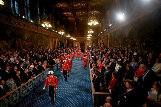 Yeomen of the Guard, wearing traditional uniform, walk through the Royal Gallery before the State Opening of Parliament in the House of Lords. PIC: Hannah McKay/PA Wire