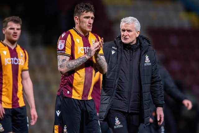 BUY-IN: Top-scorer Andy Cook (centre) and manager Mark Hughes (right) have bought into the Bradford City narrative