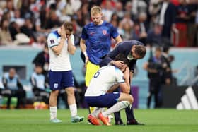 Harry Maguire of England is consoled by Gareth Southgate, after the team's 2-1 defeat to France in the World Cup quarter-final in Qatar on Saturday night. (Picture: Catherine Ivill/Getty Images)