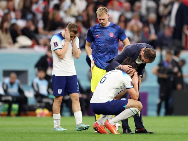 Harry Maguire of England is consoled by Gareth Southgate, after the team's 2-1 defeat to France in the World Cup quarter-final in Qatar on Saturday night. (Picture: Catherine Ivill/Getty Images)