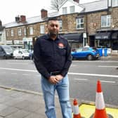 Banner Cross sub-postmaster Nasar Raoof next to a hole dug for a street tree opposite his business on Ecclesall Road, Sheffield