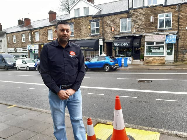 Banner Cross sub-postmaster Nasar Raoof next to a hole dug for a street tree opposite his business on Ecclesall Road, Sheffield