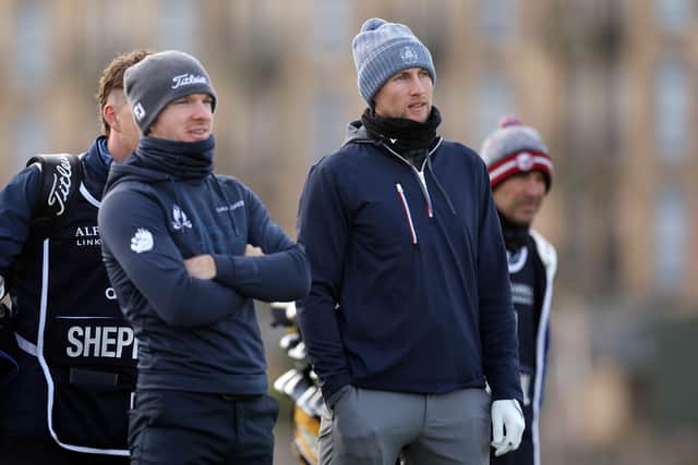 Joe Root, right, looks on across the second hole alongside Laird Shepherd on day one of the Alfred Dunhill Links Championship at St. Andrews. Photo by Oisin Keniry/Getty Images.