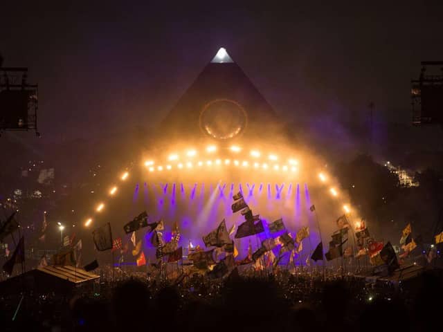 Revellers watch as The Killers perform on the Pyramid Stage at Glastonbury Festival 2019 (Photo: OLI SCARFF/AFP via Getty Images)
