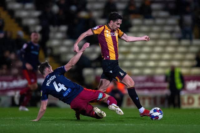Bradford City midfielder Alex Gilliead evades Carlisle United rival Owen Moxon on Tuesday night. Picture: Bruce Rollinson.