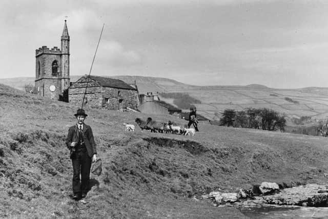 An elderly man walking to the river carrying a fishing-rod at Hawes, Upper Wensleydale in 1950. (Pic credit: Bertram Unne / Fox Photos / Getty Images)