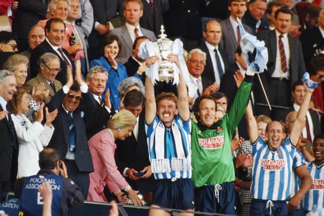Coventry City captain Brian Kilcline lifts the trophy after the 1987 FA Cup Final between Coventry City and Tottenham Hotspur at Wembley Stadium. Their quarter final victory had been the first James had witnessed in more than 20 years, whilst in what he describes as his "religious wilderness".   Photo by Chris Cole/Allsport/Getty Images