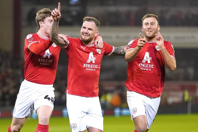 IN IT TOGETHER: Barnsley's James Norwood (centre) celebrates scoring his side's second goal in the 4-2 win over Sheffield Wednesday Picture: Tim Goode/PA