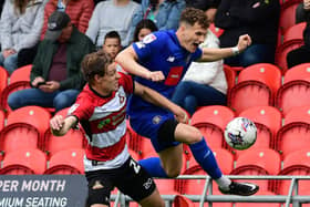 Picture: Andrew Roe/AHPIX LTD, Football, Sky Bet League Two, Doncaster Rovers v Harrogate Town, Eco-Power Stadium, Doncaster, UK, 05/08/23, K.O 3pmHoward Roe>>>>>>07973739229Doncaster Rovers' Joe Ironside battles for the ball with Harrogate Town's Toby Sims