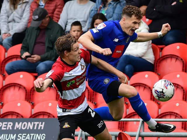 Picture: Andrew Roe/AHPIX LTD, Football, Sky Bet League Two, Doncaster Rovers v Harrogate Town, Eco-Power Stadium, Doncaster, UK, 05/08/23, K.O 3pm
Howard Roe>>>>>>07973739229

Doncaster Rovers' Joe Ironside battles for the ball with Harrogate Town's Toby Sims